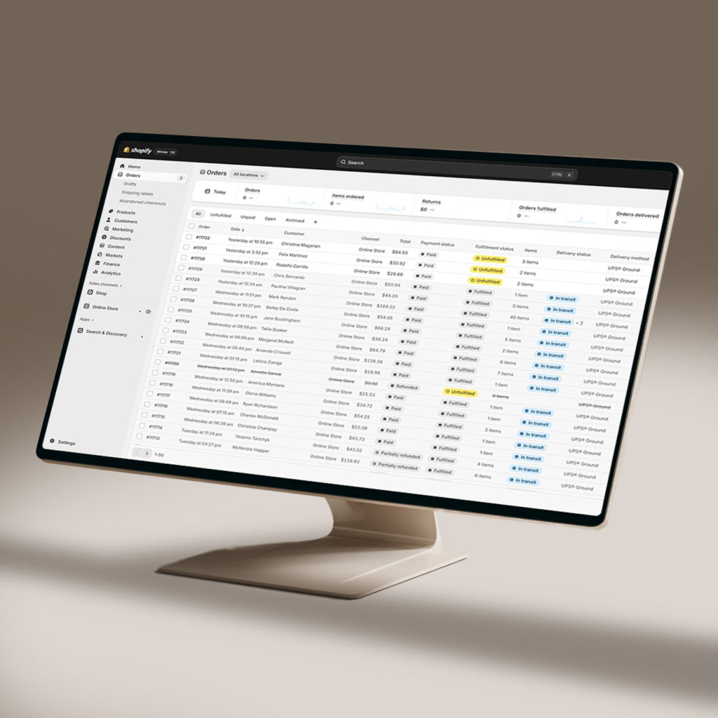 Ecommerce architecture spreadsheet on desktop monitor showing product inventory data table with columns for orders, pricing, and shipping information